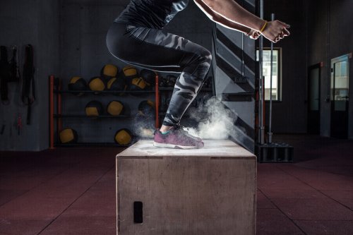 A woman doing a box jump.