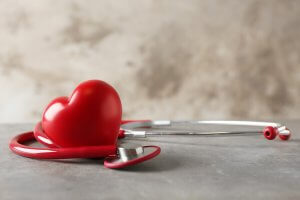 A heart next to a stethoscope.