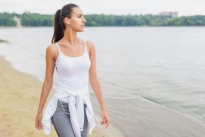A woman walking by the beach.