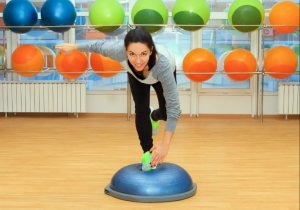 A woman using a bosu ball.