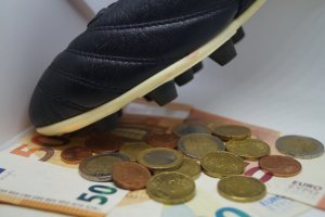 Euros next to soccer cleats.