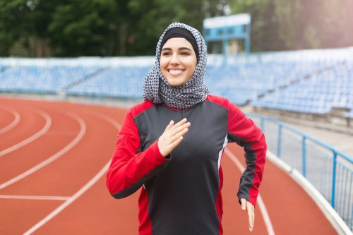 Female muslim athlete running