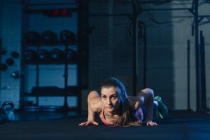 Girl doing burpees in her metabolic training routine.