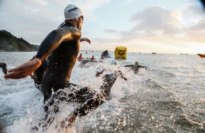People swimming during an Ironman triathlon.