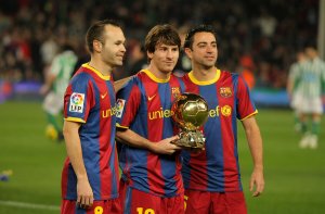 Three Barcelona soccer players on the field.
