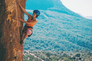 Woman rock climbing outside.