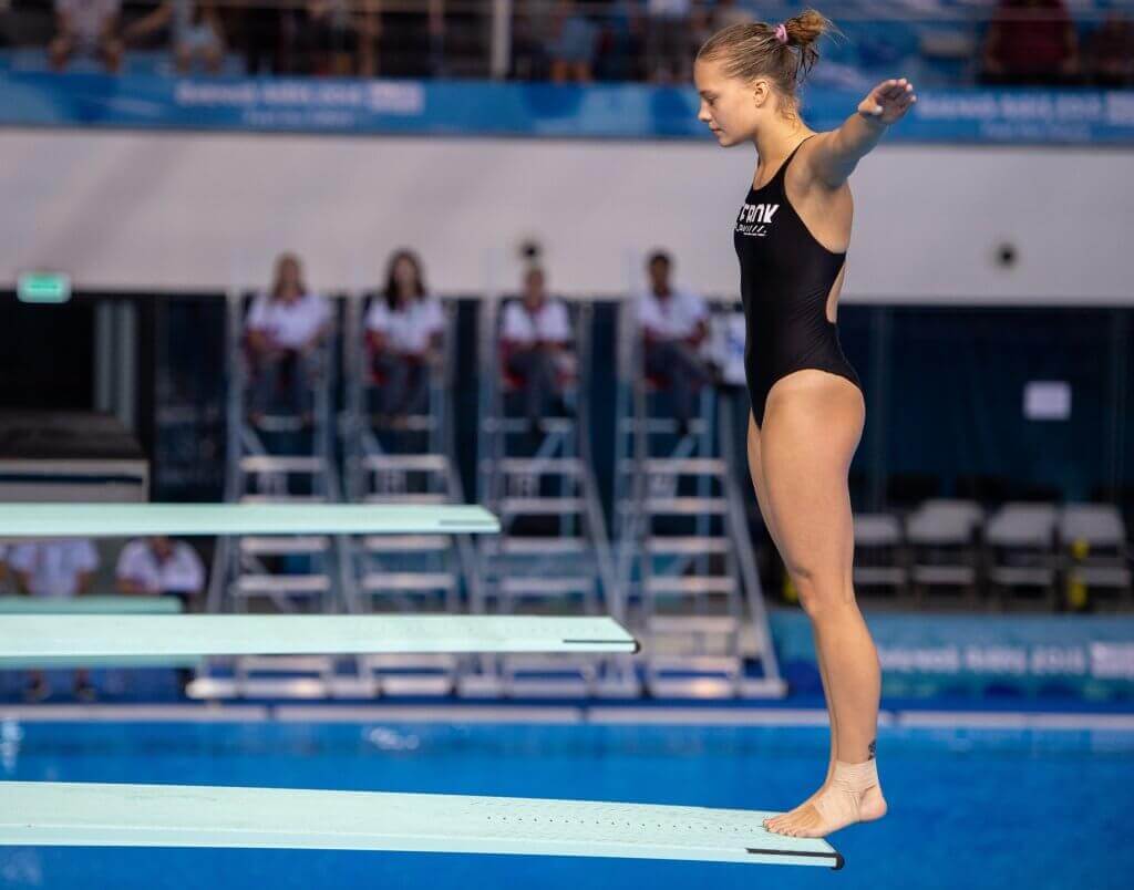 A diver about to jump off the diving board.