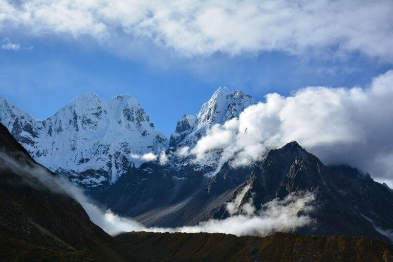 The Kangchenjunga mountain peaking between the clouds