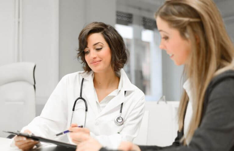 A doctor and patient during the inteview stage of a sports medical examination