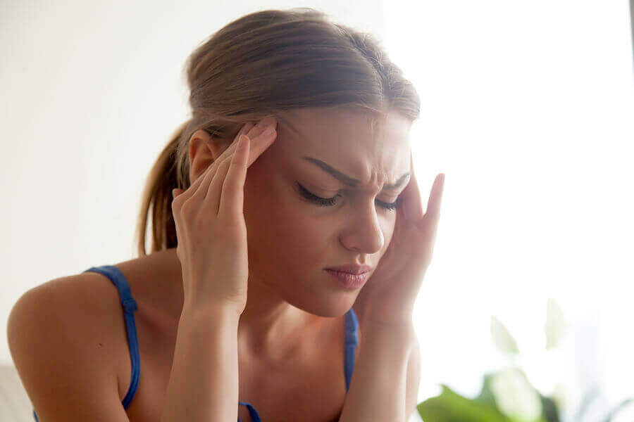 A woman experiencing a migraine.