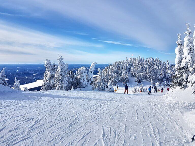 People snowboarding down Mont Tremblant one of the best ski locations in the world