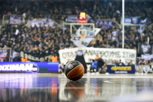 A basketball in the middle of the court to simbolize an important sport in the United States