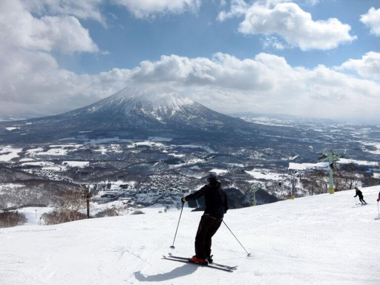 Two people skiing down one of the tracks in Niseko