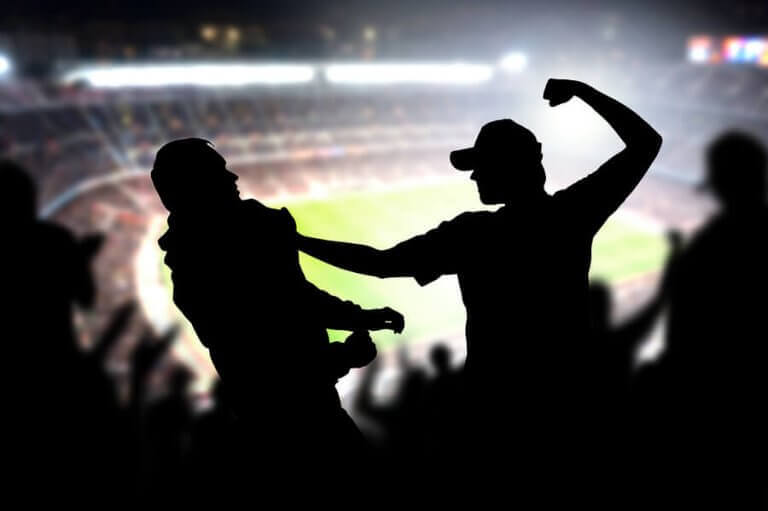 Two soccer fans fighting violently inside a stadium