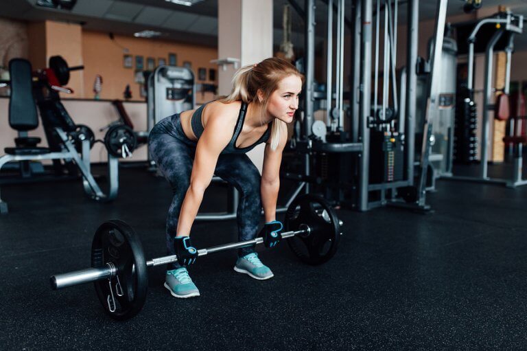 A girl strength training in the gym to prevent sarcopenia