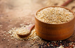 A bowl full of quinoa and a wooden spoon.