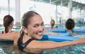 A group of women doing aquatic therapy.