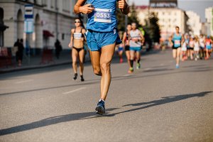 A male runner running in a marathon.
