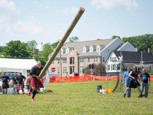 A man doing a caber toss, which is one of the more cultural throwing sports.
