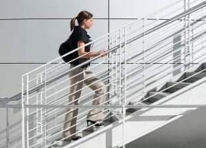 A woman climbing the stairs to improve circulation in her legs.