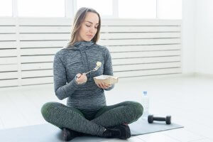 A woman eating an alkaline diet to regulate her pH levels.