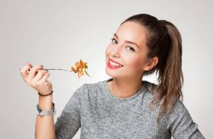 A woman enjoying some delicious healthy food.