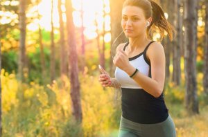 A woman running in the woods.