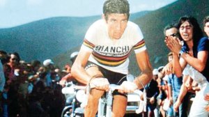 Felice Gimondi riding by a crowd.