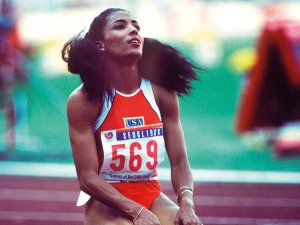 Florence Griffith kneeling after a race.