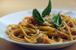 Pasta with red sauce and basil.