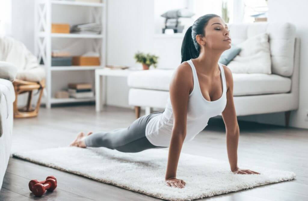 A woman doing prone exercises while breathing deeply