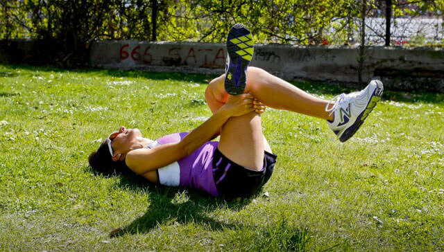 A woman stretching her legs.