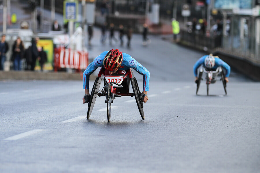 Two disabled athletes in the middle of a Paralympic competition