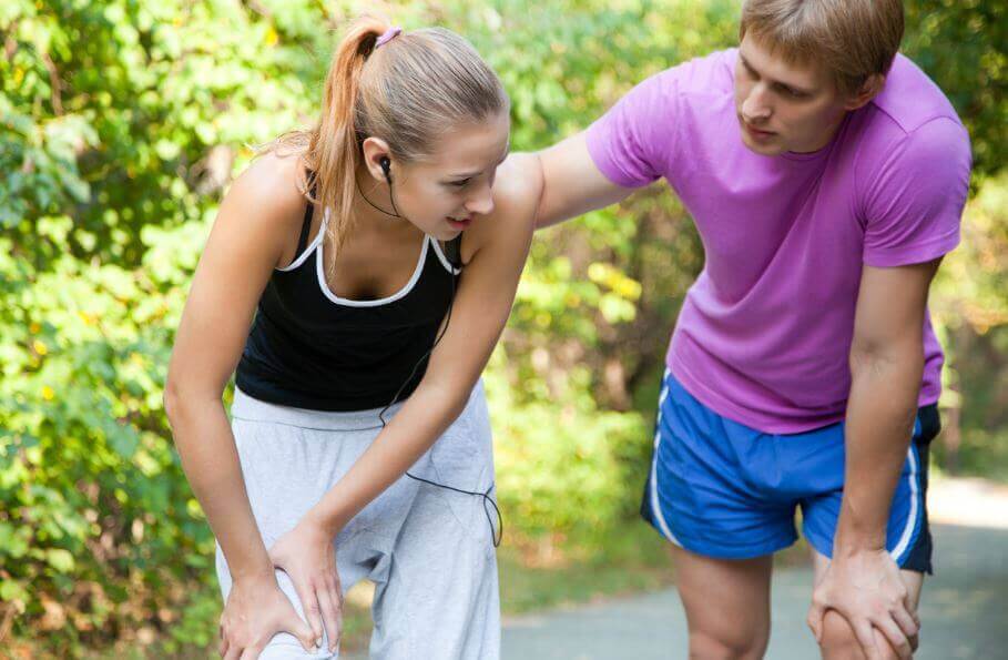 A girl feeling pain in her leg after running due to muscle strains
