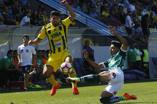Two players from the Santiago Wanderers and the Everton team in the middle of a classic encounter of Chilean soccer