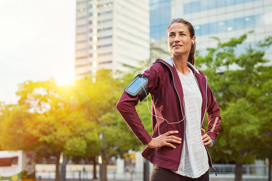 A woman running outside to boost the health benefits of her workout
