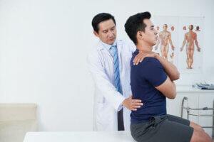 A man at the doctors to prevent lower back pain.
