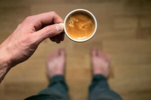 A person holding a cup of coffee.