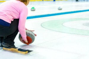 A woman curling in Switzerland.