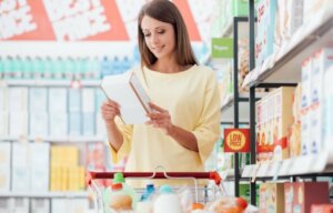 A woman reading nutrition labels at the store.