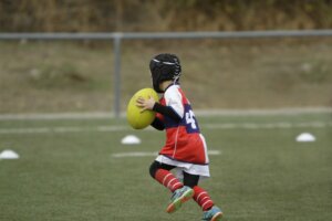 I child wearing head protection to avoid concussion in children's sports.