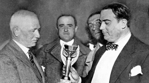 A photo of Jules Rimet giving a trophy.
