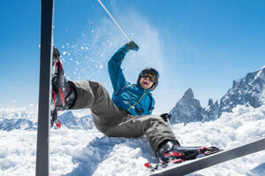 A man falling while skiing.
