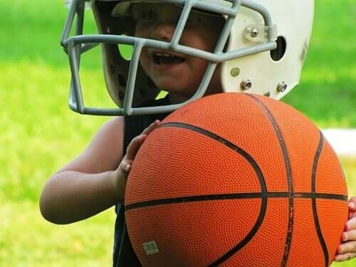 A gifted child athlete with a football helmet on.