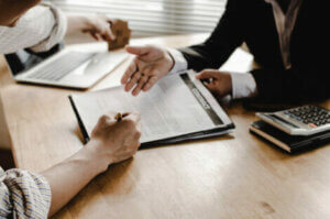 A person signing a legal contract.