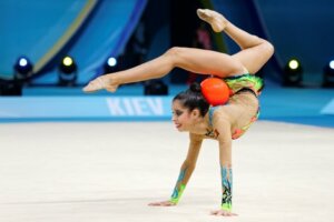 An individual rhythmic gymnast with a ball.