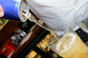 Someone making a mixed drink containing caffeine.