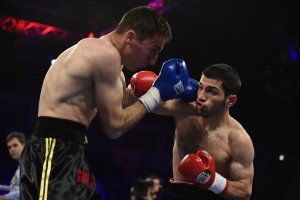 Two people in a boxing match.
