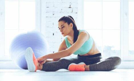 Woman stretching her legs and obliques without leaving home
