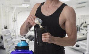 An athlete adding supplements to his drink.
